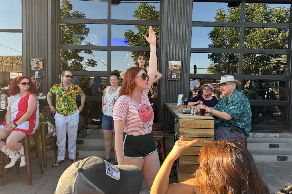 A performer recites Shakespeare at a bar. 