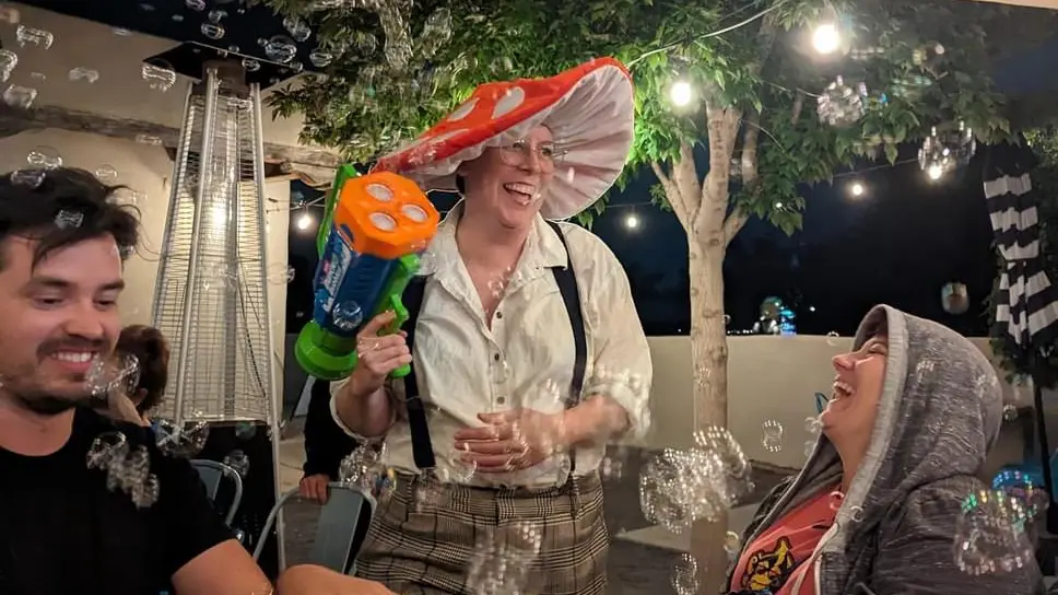 A Shakespeare performer uses a bubble gun