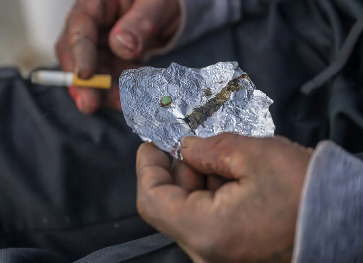 Several dozen homeless folks currently camp under interstate I-40 and first street. Many express frustration of authorities coming by everyday and kicking them out but decide to return an hour later. This has been their daily routine for months now. Pictured is a fentanyl pill about to be consumed. Photo by Roberto E. Rosales / City Desk Abq