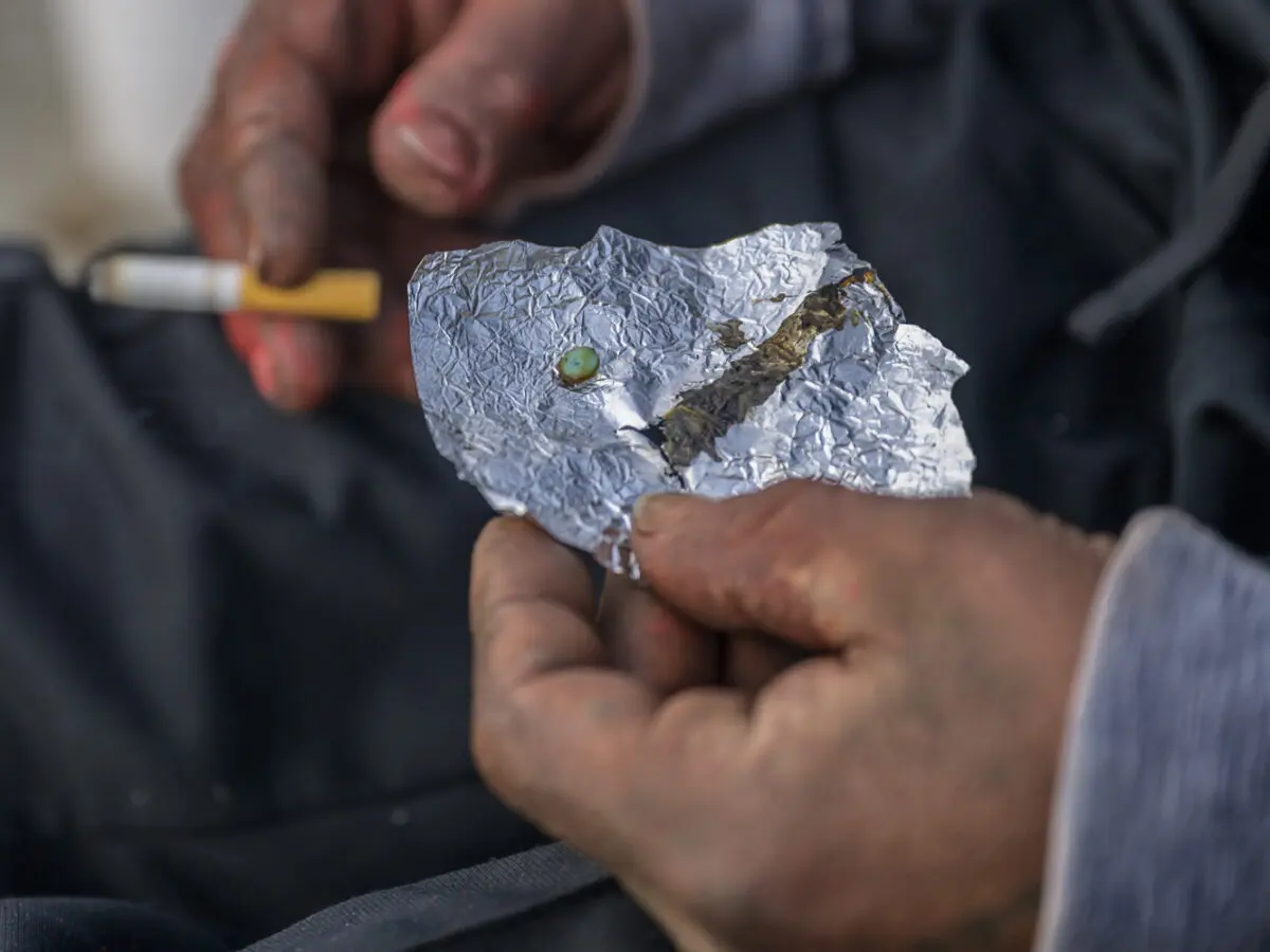 Several dozen homeless folks currently camp under interstate I-40 and first street. Many express frustration of authorities coming by everyday and kicking them out but decide to return an hour later. This has been their daily routine for months now. Pictured is a fentanyl pill about to be consumed. Photo by Roberto E. Rosales / City Desk Abq
