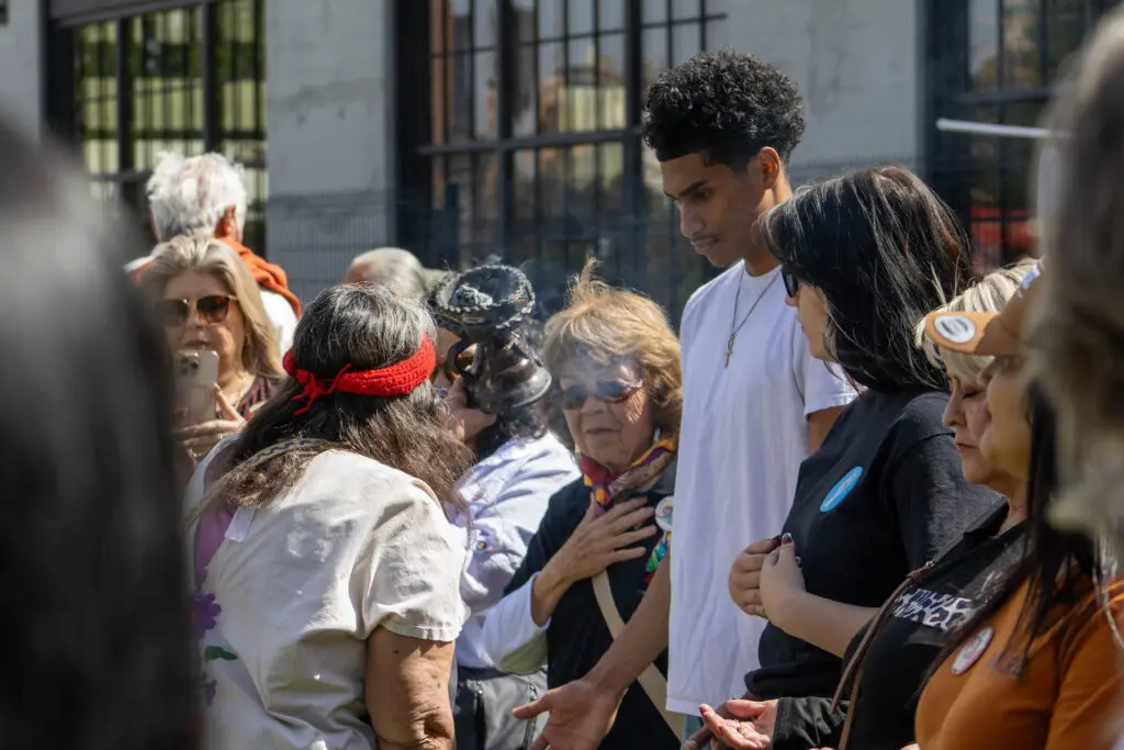 A blessing during the Voces de la Comunidad event.