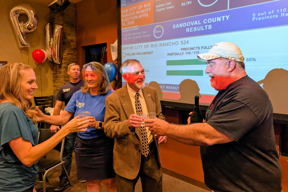 Rio Rancho's new mayor Paul Wymer, center, celebrates with champagne on election night at Turtle Mountain. (Kevin Hendricks)