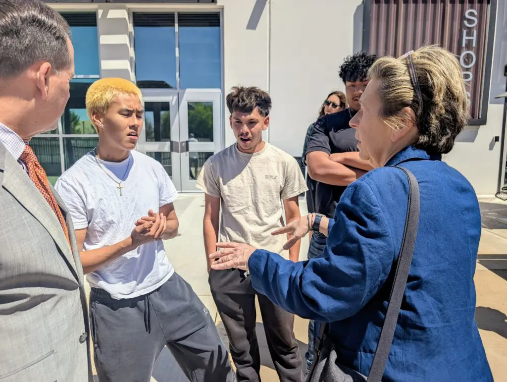 Bobby Garcia, a 10th-grade student at RioTECH, talks with AFT President Randi Weingarten, right, and RRPS Superintendent Dr. Bobby Dodd on May 18. (Kevin Hendricks)