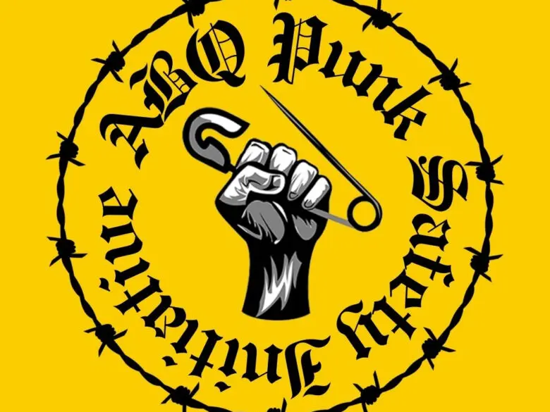 The logo of the Punk Safety Intiative, a fist holding a safety pin
