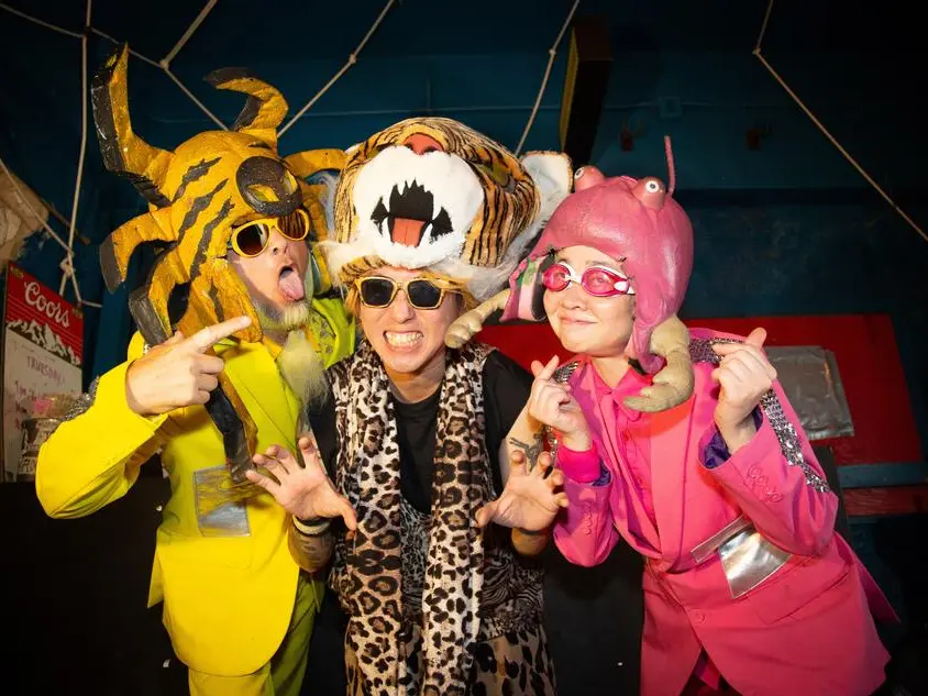 Three Japanese musicians in odd animal costumes