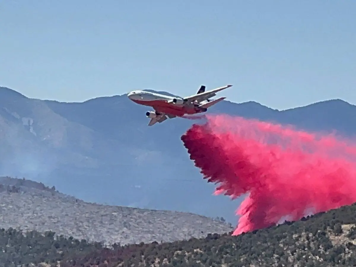 An air tanker drops fire retardant on the Deer Canyon Fire south of Mountainair (NM Foretry Div., Jun 21, 2026)