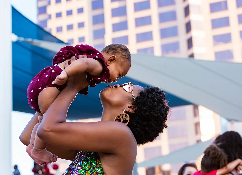 A mother shares a moment with her child at Albuquerque's 2021 Juneteenth celebration at Civic Plaza. (Photo courtesy NM Juneteenth/bccofnm.org)