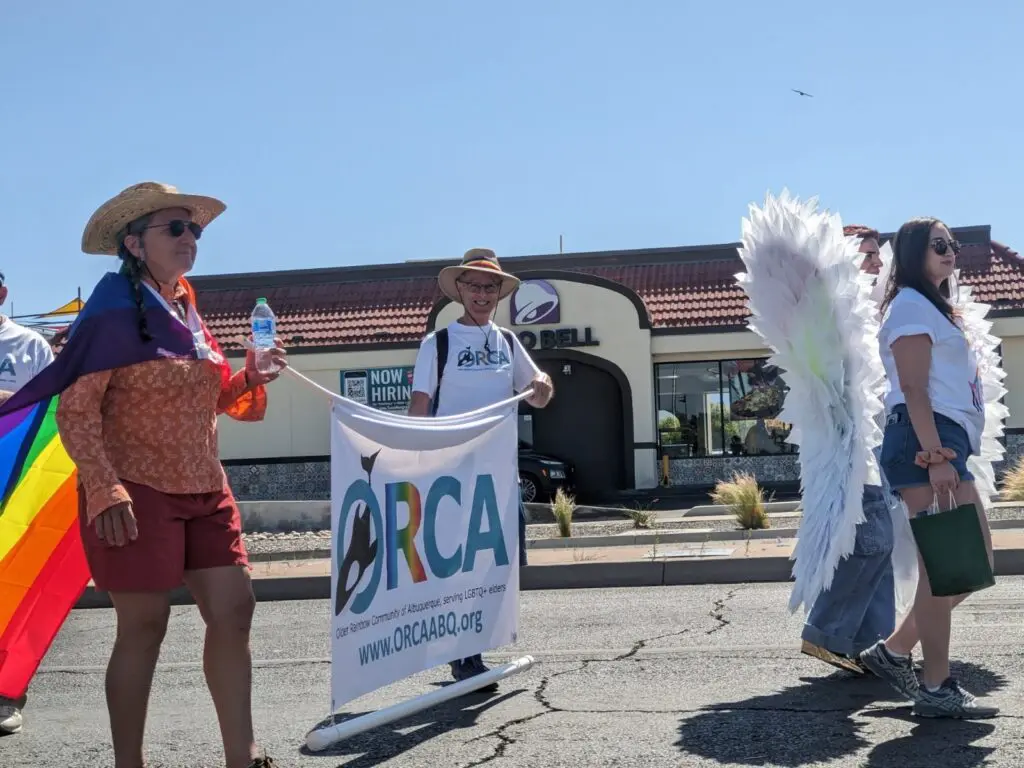 Craig Vitamanti (center) walking in a Pride Parade. (Courtesy of ORCA)