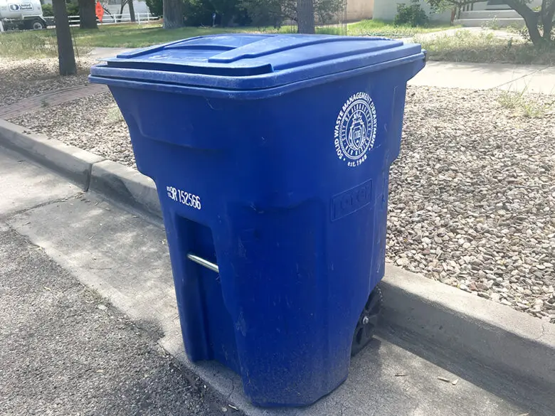 A blue recycling bin sits along an Albuquerque street as the City Council will consider a proposed ordinance that would expand recycling access to all apartment renters and municipal buildings (Jesse Jones)