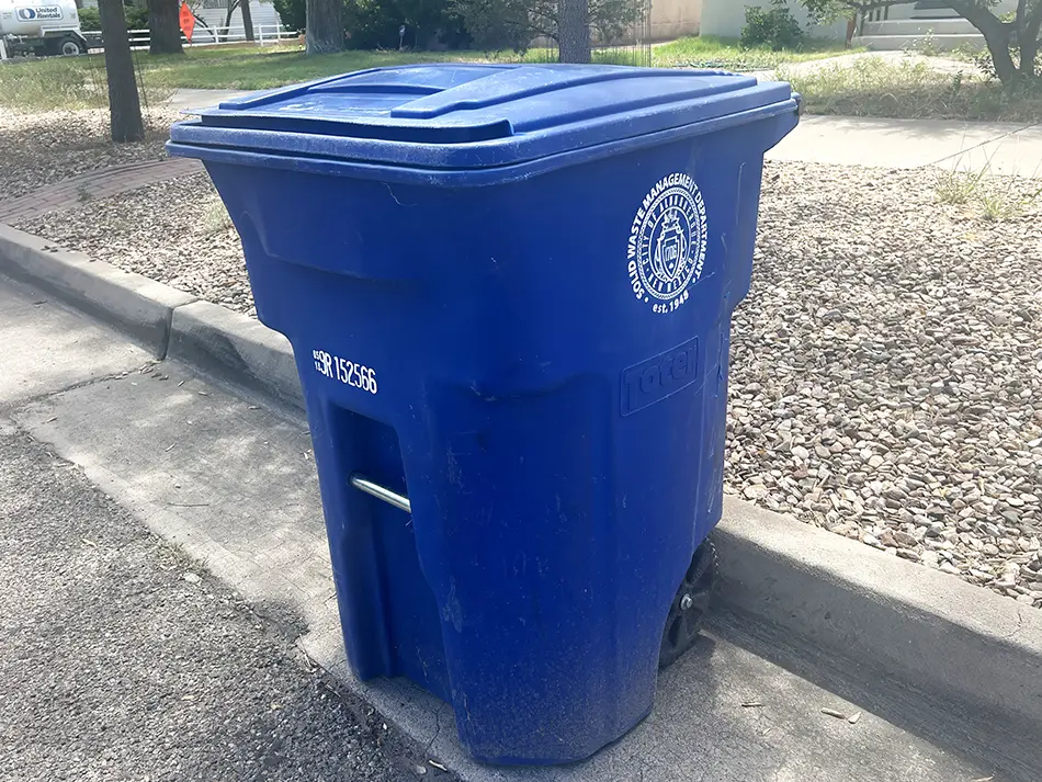 A blue recycling bin sits along an Albuquerque street as the City Council will consider a proposed ordinance that would expand recycling access to all apartment renters and municipal buildings (Jesse Jones)