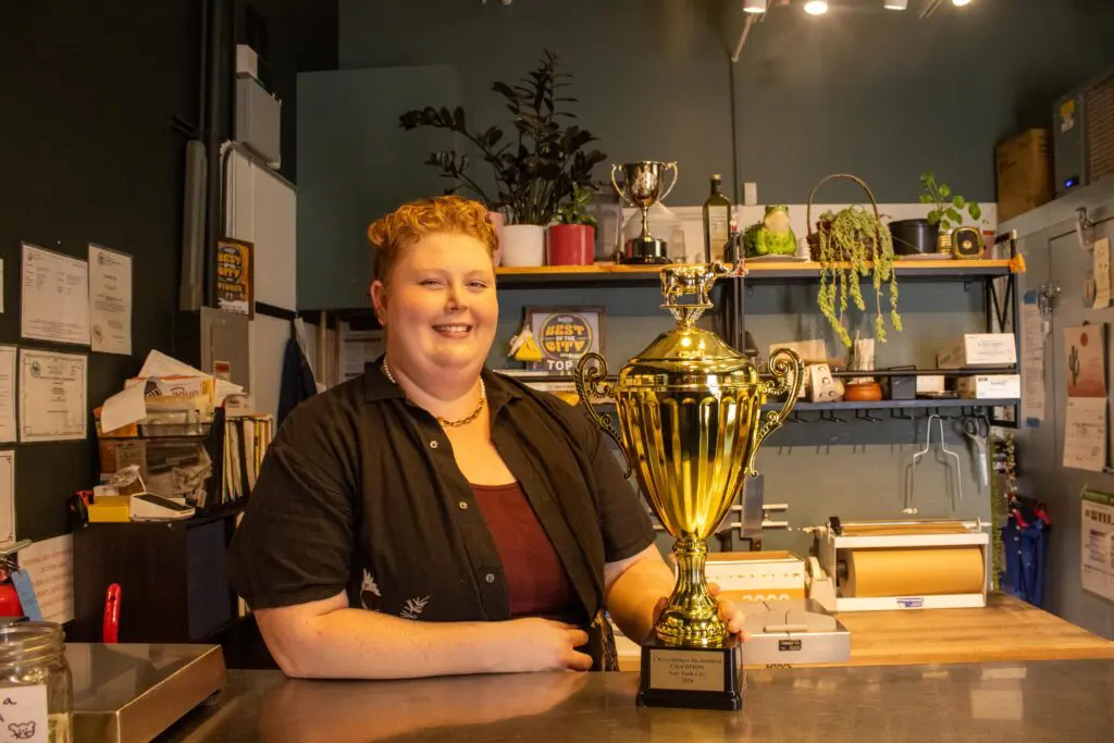 Hanna Lee with her Best Cheesemonger in USA trophy at the Mouse Hole Cheese Shop (Photo by Sara Atencio-Gonzales)