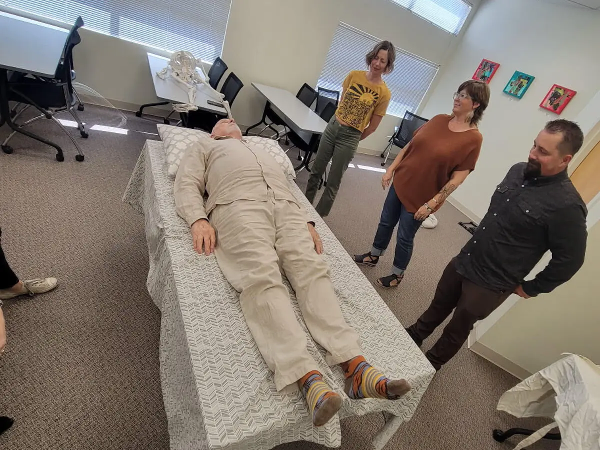 A volunteer laying down during a (Death) Shrouds 101 class. (Courtesy of the New Mexico Deathcare Network)