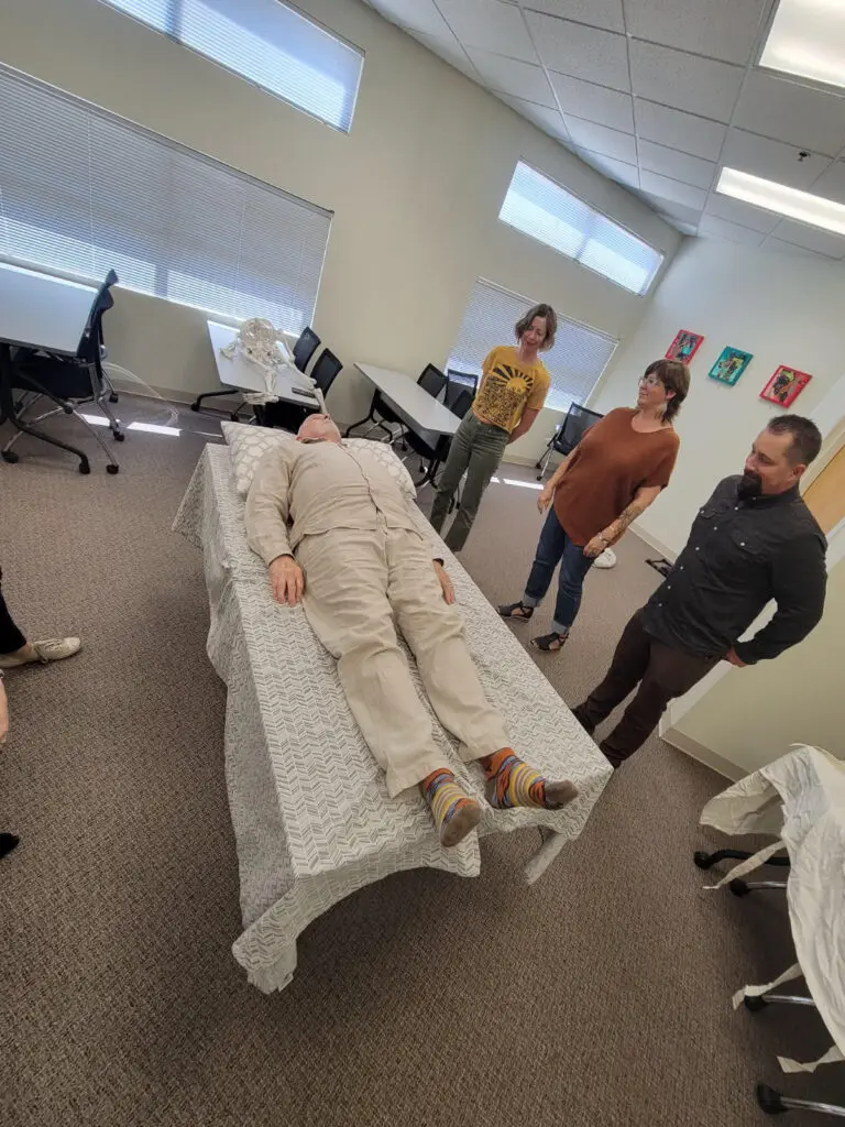 A volunteer laying down during a (Death) Shrouds 101 class. (Courtesy of the New Mexico Deathcare Network)