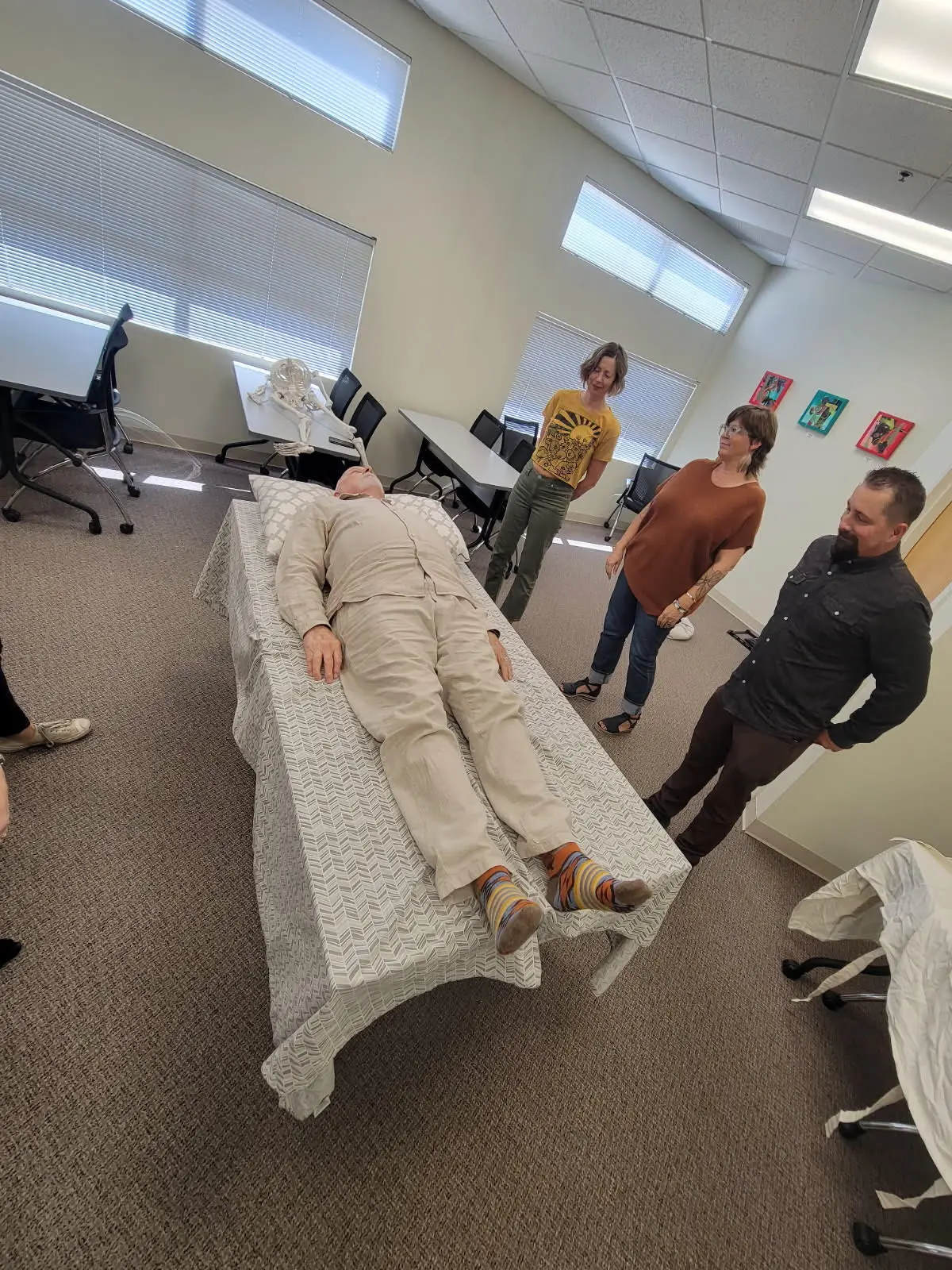 A volunteer laying down during a (Death) Shrouds 101 class. (Courtesy of the New Mexico Deathcare Network)