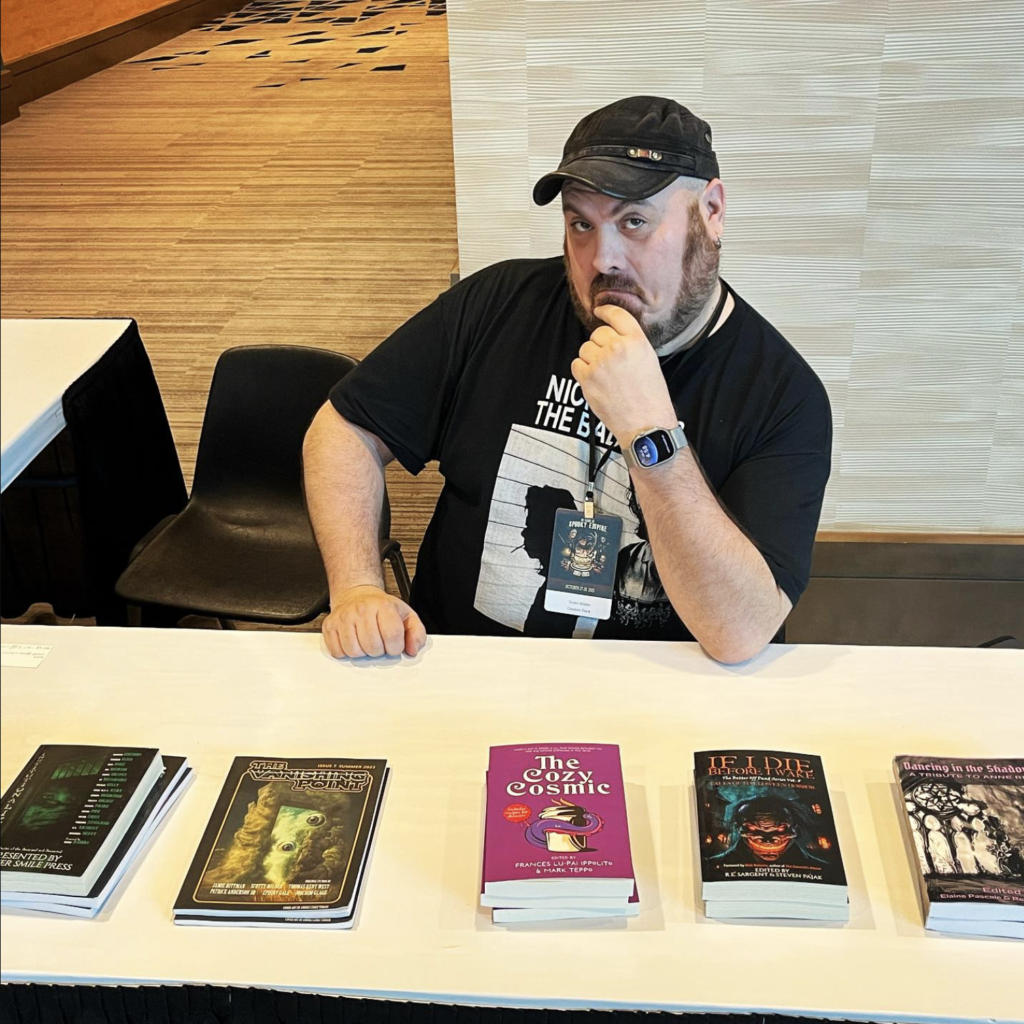 Scotty Milder with a few of the books his works are featured in. (Courtesy of Scotty Milder)