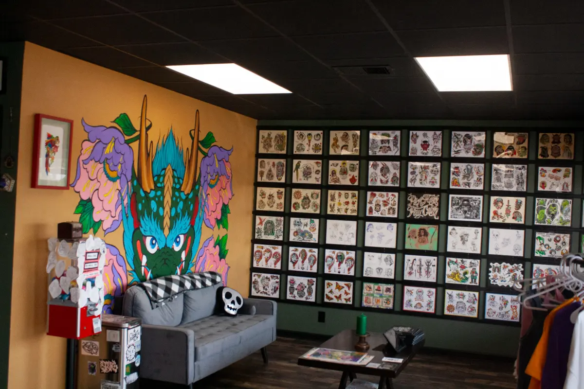 The interior of a tattoo shop adorned with flash art.