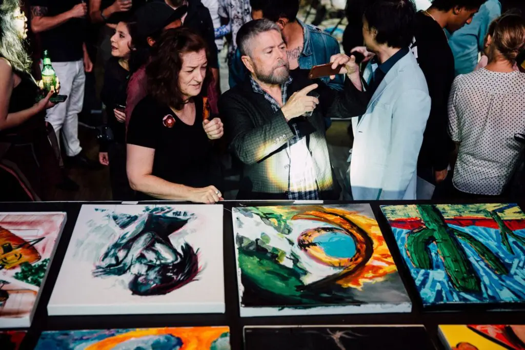 Audience members looking at the finished art after an Art Battle (Courtesy of Art Battle)