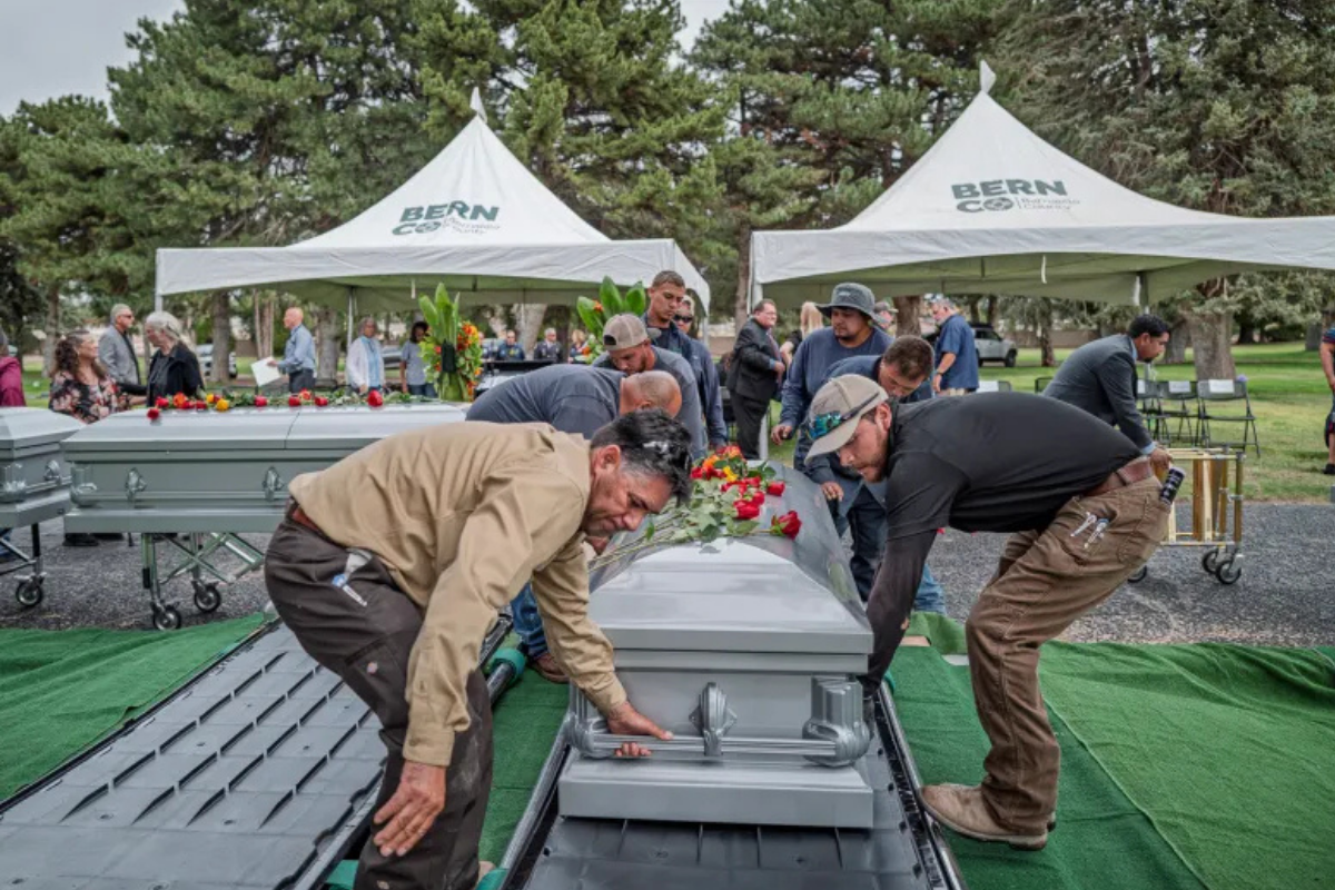 Bernalillo County held its annual formal burial of indigent and unclaimed residents last year at Fairview Memorial Park. Director’s Choice Mortuary Services and the county conducted the ceremonial services, which included a dignified and appropriate disposition of the cremains of 171 people. Pastor Richard Mansfield delivered offer the eulogy. Pictured are cemetery workers lowering the caskets in the final resting place. Photo by Roberto E. Rosales / New Mexico News