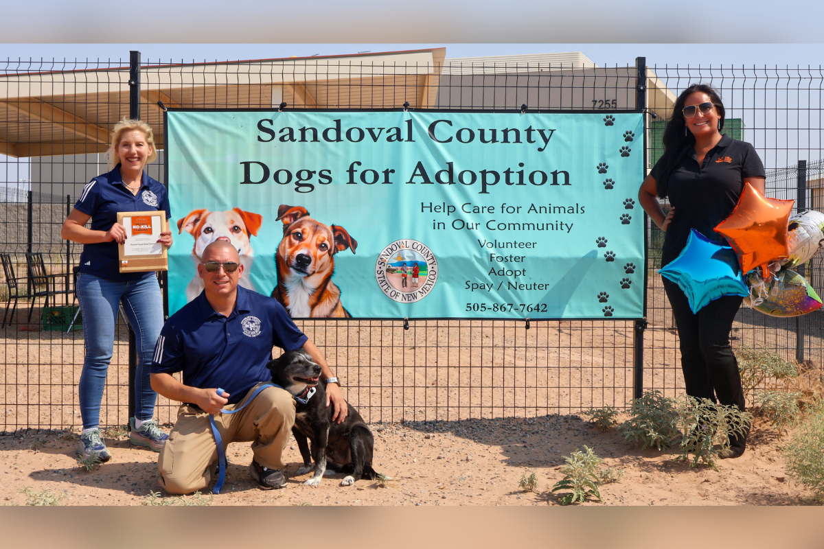 Callie the dog (center) is joined by Angelita Sampaio (right), Best Friends Animal Society Senior Specialist, Network Partner Mobilization, and Sandoval County Animal Care team leaders, Kimberly Jaramillo, Assistant Director, and Mark Webb, Supervisor, to celebrate the NO-KILL SHELTER designation.