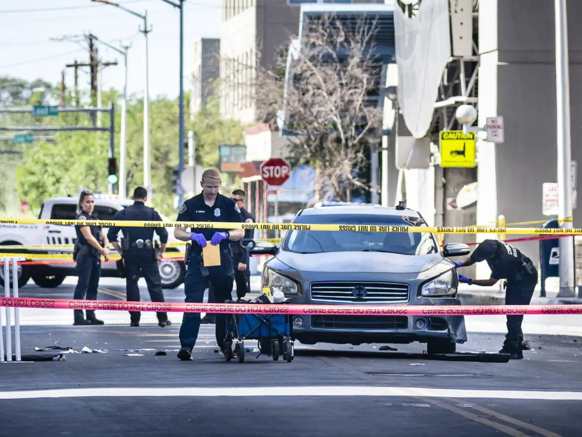 Albuquerque police officers gather evidence behind crime scene tape. Photo by Roberto E. Rosales/City Desk ABQ