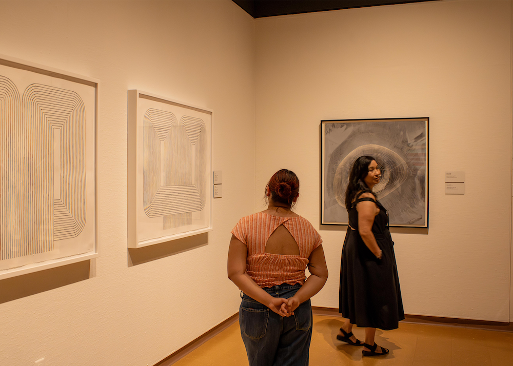 Two guests at the UNM Art Museum reopening reception (Photo by Sara Atencio-Gonzales)
