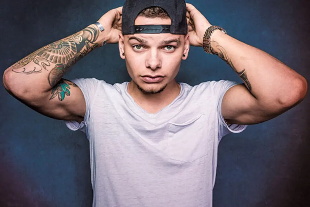Photo of tattooed country music star Kane Brown wearing a baseball cap.