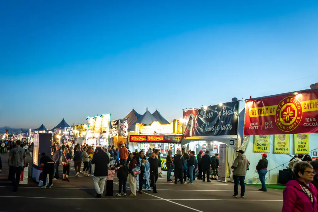 Visitors browse vendors along Main Street at dawn during the Albuquerque International Balloon Fiesta. (Photo by Brad Beck, Albuquerque International Balloon Fiesta)