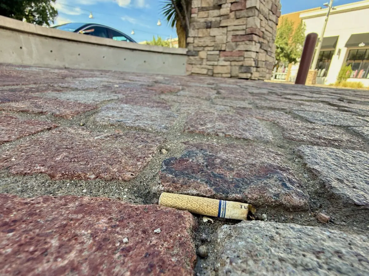 A discarded cigarette butt rests on a sidewalk in ABQ Uptown. Photo by Roberto E. Rosales / New Mexico News