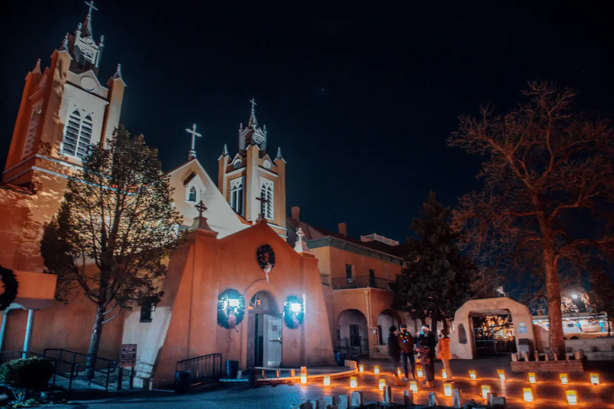 Luminarias glow outside San Felipe de Neri Church in Old Town Plaza in Albuquerque. Photo by Roberto E. Rosales for the Paper Credit: The Paper.
