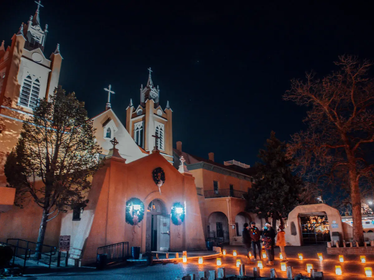 Luminarias glow outside San Felipe de Neri Church in Old Town Plaza in Albuquerque. Photo by Roberto E. Rosales for the Paper Credit: The Paper.