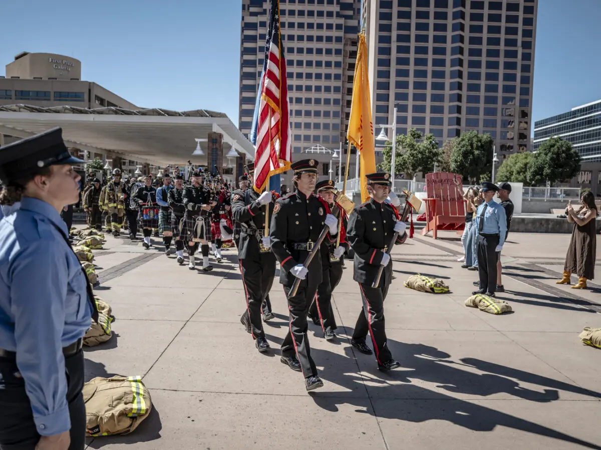 Firefighters parade the American flag on Civic Plaza.