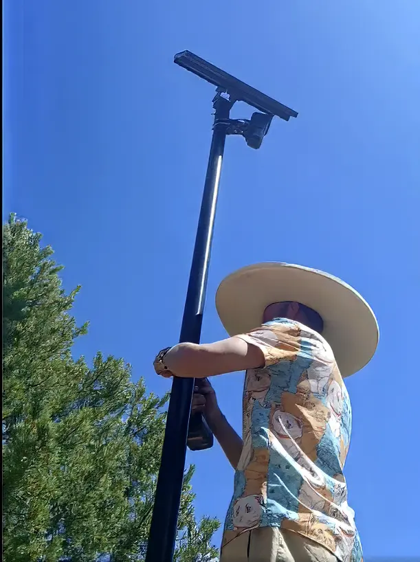 A screenshot from Jevon Martinez’s social media video shows him removing a Flock Safety camera. Martinez faces felony charges after Bernalillo County sheriff’s deputies found 10 camera setups in his truck, according to a criminal complaint.