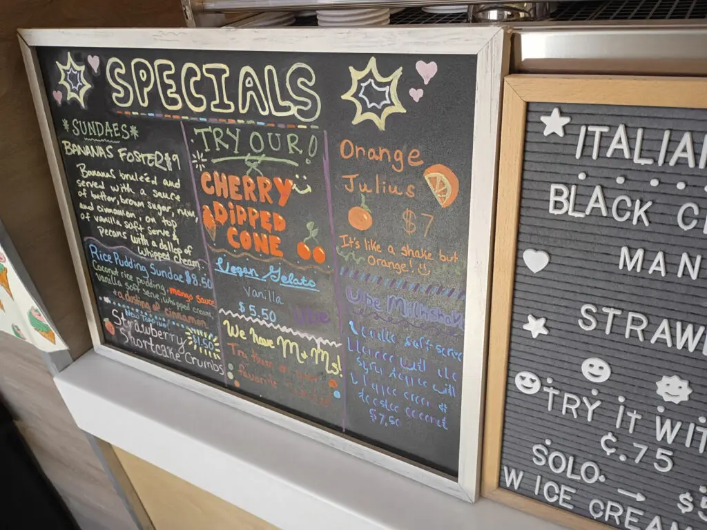 A chalkboard listing ice cream specials.