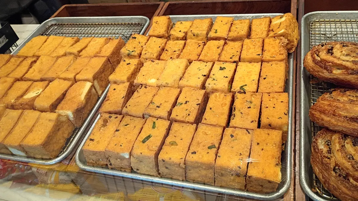 A tray of fried tofu sits in a Vietnamese restaurant.