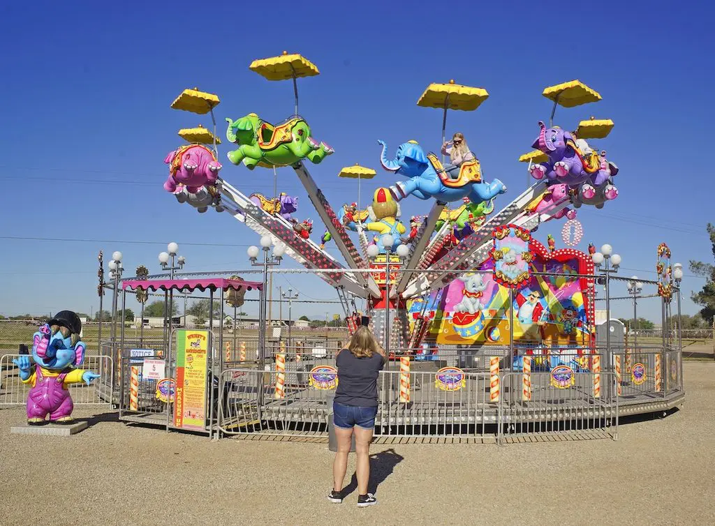 Michelle Silva, of Mi Via, watches as two of her clients enjoy one of the less intimidating rides at the Eastern New Mexico State Fair.