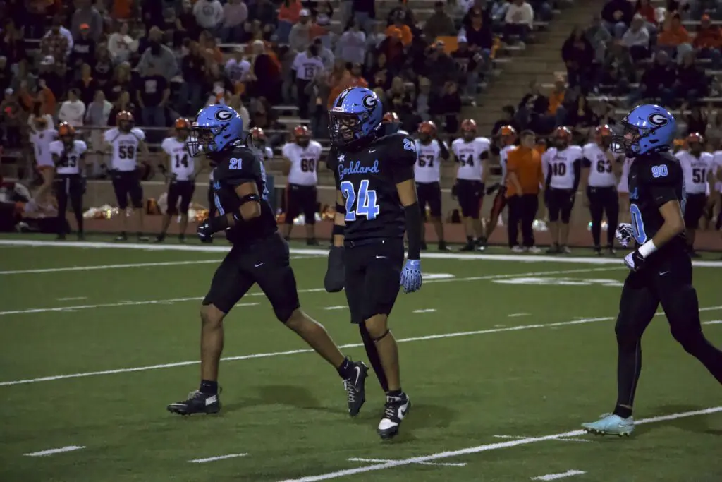 Goddard linebackers Angel Deleon (24) and Alijah Sanchez (21), and kicker Braden McDaniel (90) head off the field after an extra point against Artesia.