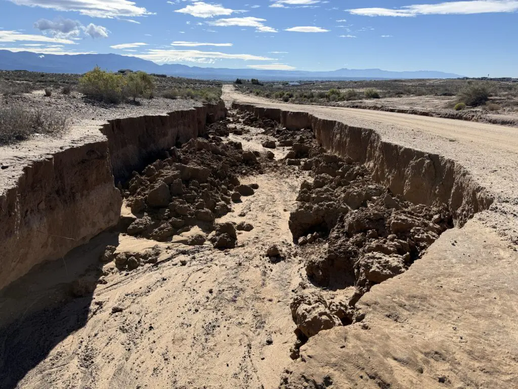 Recent storms carved trenches through roads across Rio Rancho, and the city needs residents' help tracking down every one. (Roberto E. Rosales)
