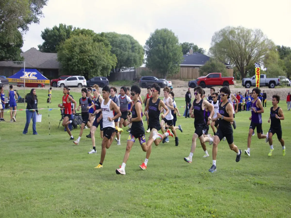 Varsity runners break out of the starting area at the Pecos Valley Invitational