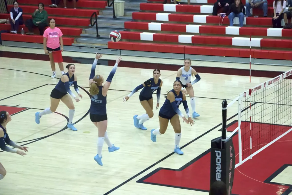 Landry Brown (6) sets up Olivia Riffell (2) for a spike in the first set against Roswell.