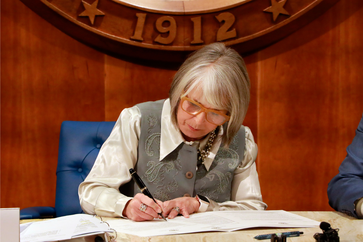 Governor Michelle Lujan Grisham signs a deal Thursday with Tokyo-based Fujitsu, one of the world's largest technology companies, to establish a quantum computing research center in New Mexico. (Courtesy of the governor's office)