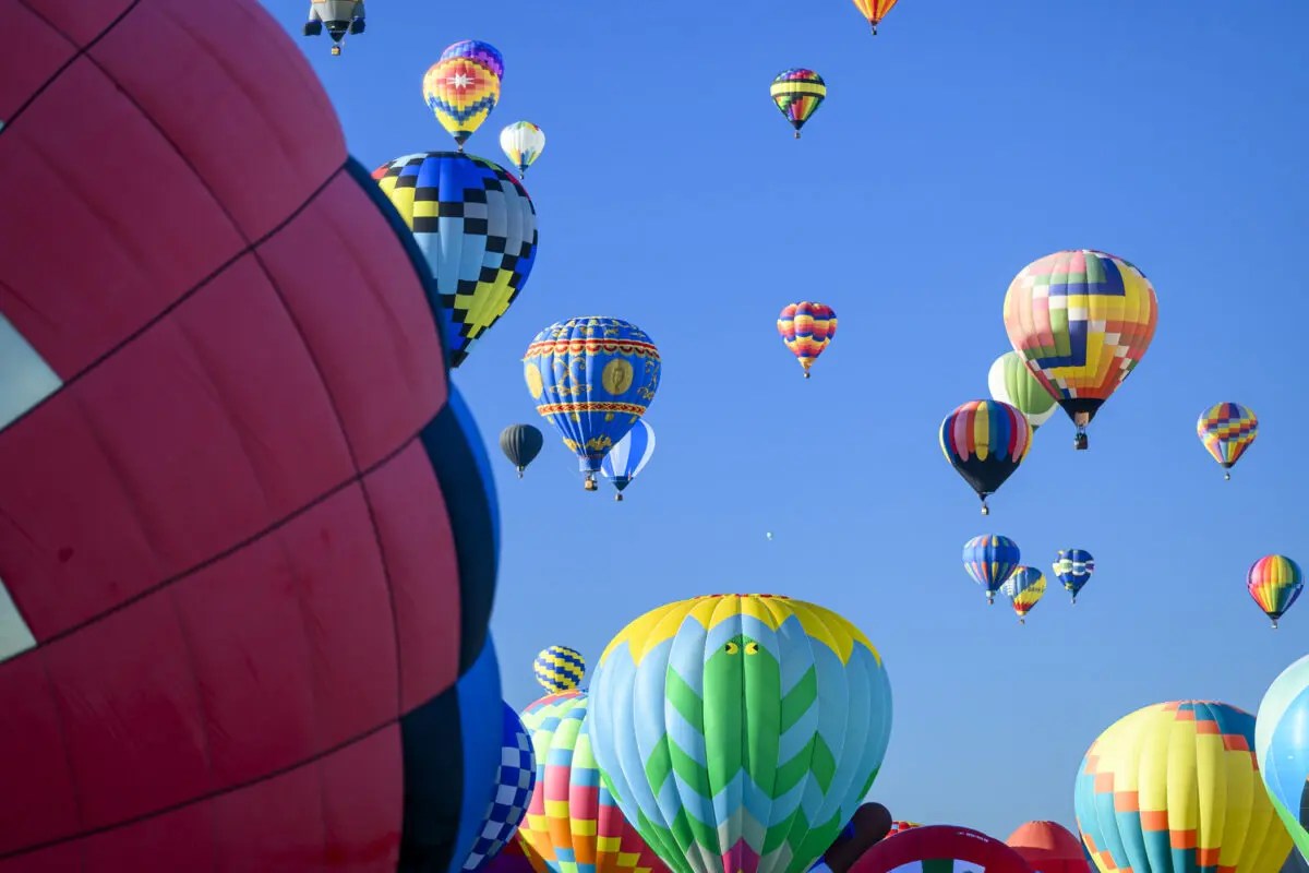 Hot air balloons fill the sky over Albuquerque during the Albuquerque International Balloon Fiesta. The annual event draws hundreds of thousands of guest visits and generates millions of dollars in economic activity for the city. Photo by Roberto E. Rosales/City Desk ABQ.