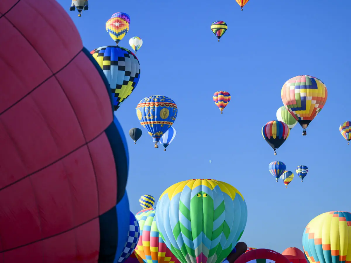 Hot air balloons fill the sky over Albuquerque during the Albuquerque International Balloon Fiesta. The annual event draws hundreds of thousands of guest visits and generates millions of dollars in economic activity for the city. Photo by Roberto E. Rosales/City Desk ABQ.