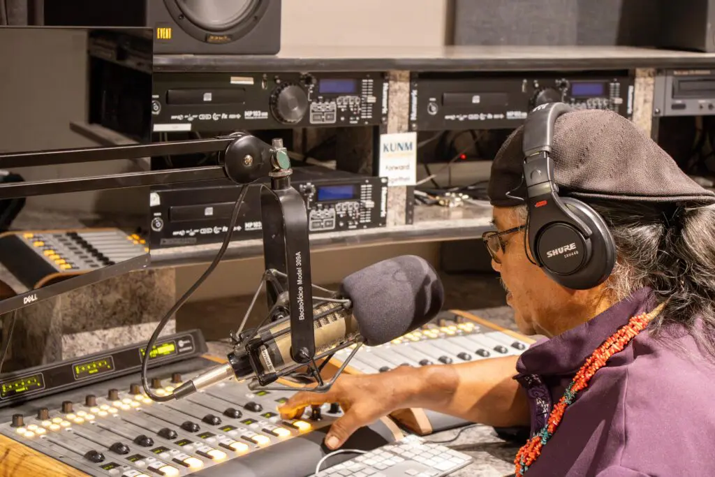 Ron Bryan explaining how an audio console works at KUNM (Photo by Sara Atencio-Gonzales)