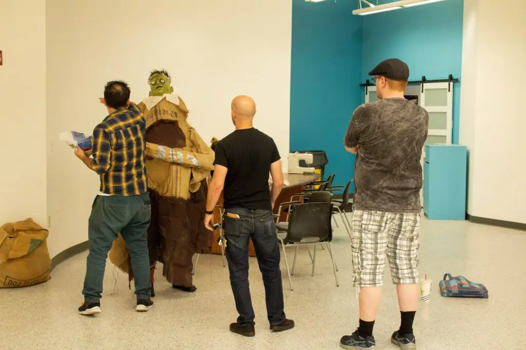 Charles Herrera (right) & Rusty Rutherford (middle) helping with final touches on costumes for This is a Haunted House (Photo by Sara Atencio-Gonzales)
