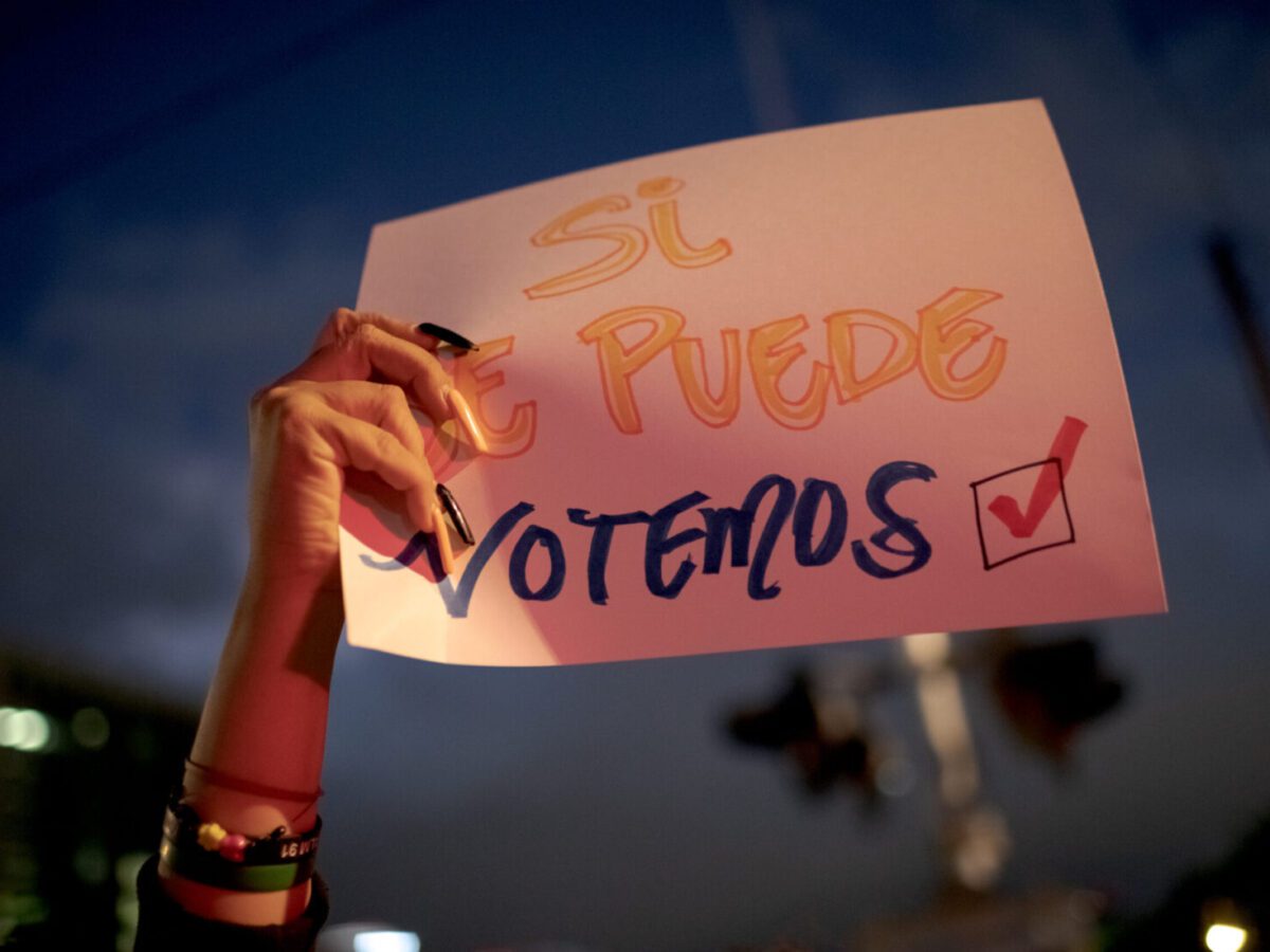 A voter holds up a pro-Harris sign at a get-out-the-vote event aimed at Latino voters in Phoenix on Nov. 3.