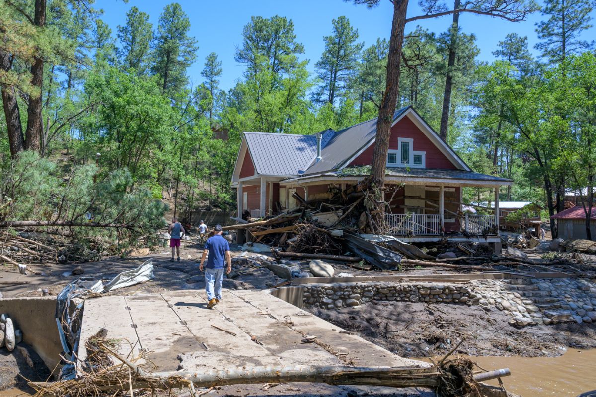 Residents of the town of Ruidoso, New Mexico walk back to their neighborhood to find what’s left of their homes a day after major flooding washed away properties and Rv’s Tuesday afternoon. Ruidoso, N.M. (AP Photo/Roberto E. Rosales)