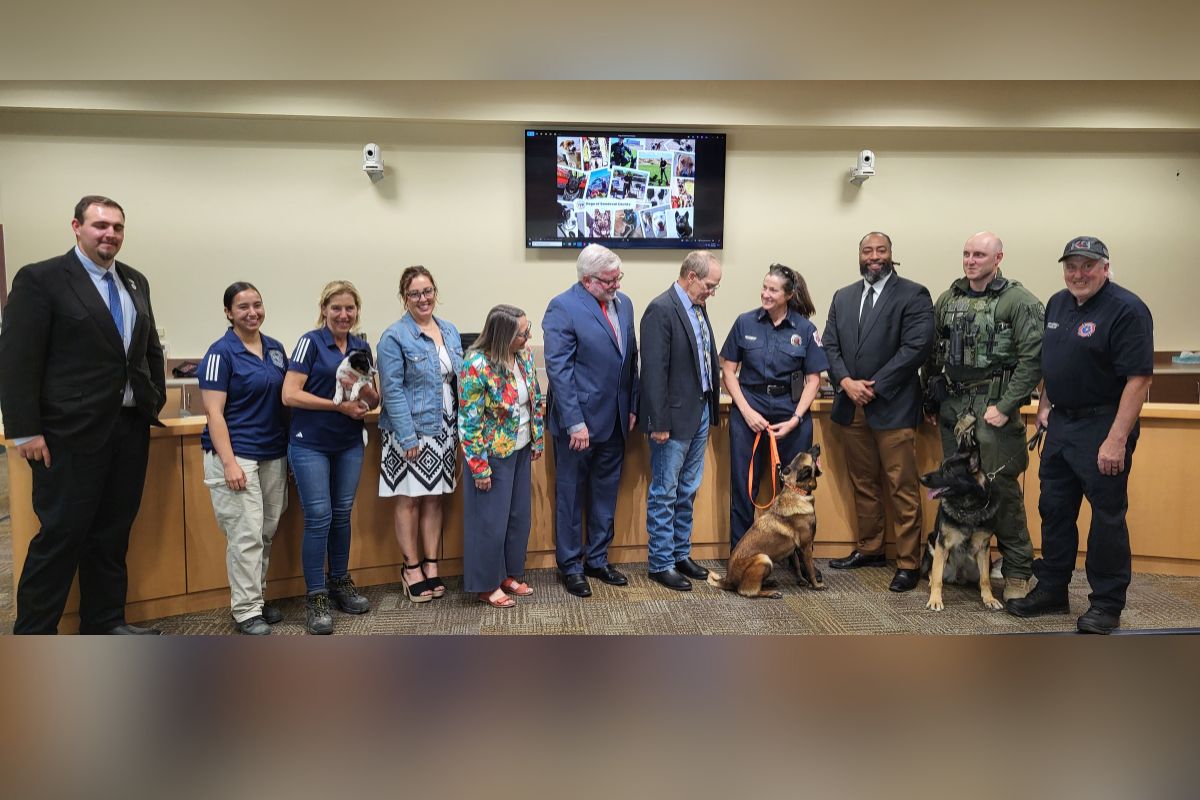 County commissioners and staff pose as National Dog Month was proclaimed Aug. 13 in Sandoval County. (Rodd Cayton)