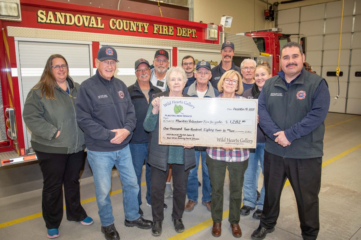Wild Hearts Gallery presented a donation of $1,282 to Humberto Macias, District Battalion Chief, and members of the Placitas Volunteer Fire Brigade on December 18. This donation was the result of a Boot Drive in honor of former gallery member David Johnson that raised $414, plus $868 which was 15% of the gallery’s holiday sales.