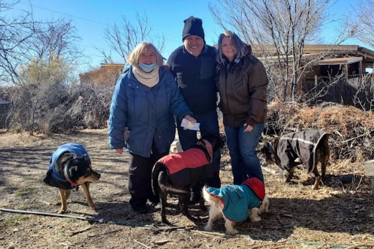 City Councilor Tammy Fiebelkorn, right, and Paul Roybal, center, present cookie fundraiser proceeds to Kindred Spirits Animal Sanctuary founder Ulla Pedersen. The couple has raised funds for the senior animal hospice for about eight years. (Courtesy photo)