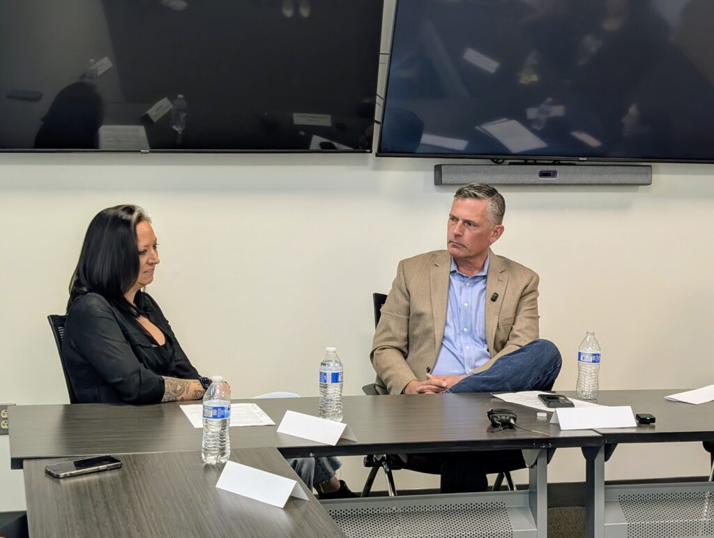 WESST President and CEO Lindsey Kay, left, and Sen. Martin Heinrich listen during a roundtable discussion at WESST's Albuquerque headquarters on May 7. (Kevin Hendricks)